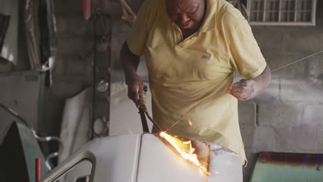 african man burning an object