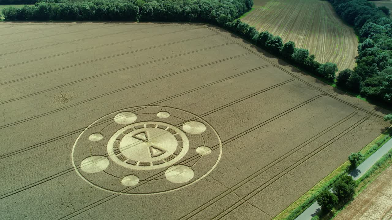 Swarraton barley field strange elaborate crop circle pattern aerial view high orbit left above Hampshire farmland