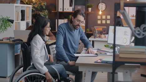 business meeting in modern office with person in wheelchair