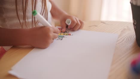a child drawing with markers on paper