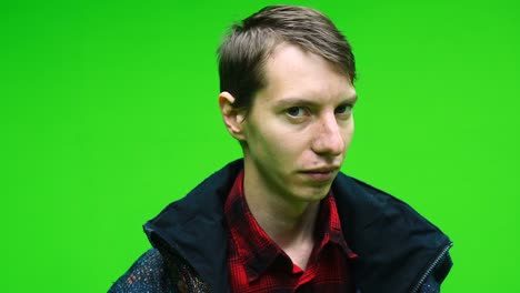 man in casual clothing shaking his head right and left he is saying no on green screen background.