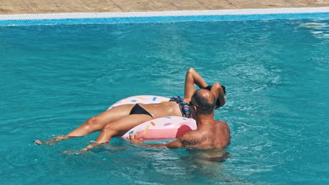 senior couple enjoying in the pool