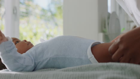 happy african american mother caring for baby at home loving mom talking to toddler soothing her child enjoying motherhood