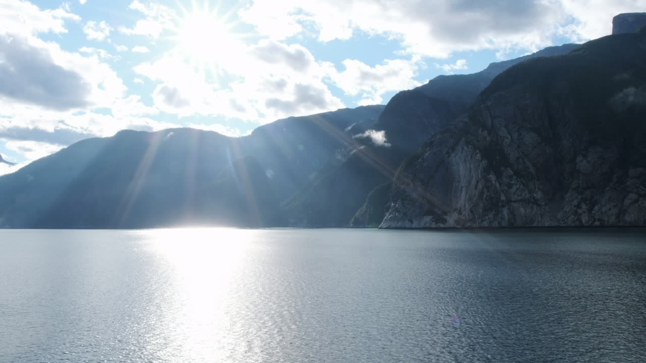 스펙트럼 태양이 바다를 비추고 화강암 절벽이 물에서 높이 솟아오른다