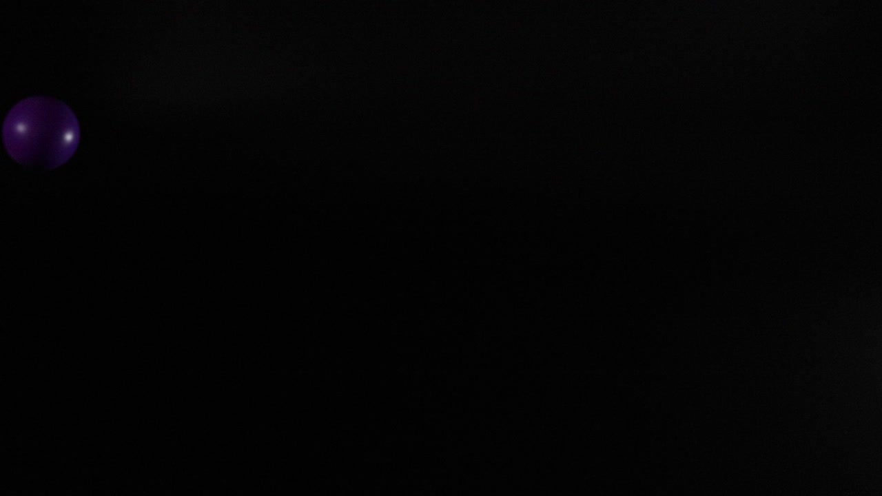Vibrant balls bouncing against a dark background