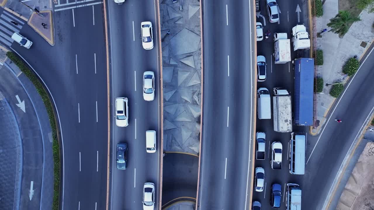 Overhead forward flight over urban traffic, with vehicles moving in ...