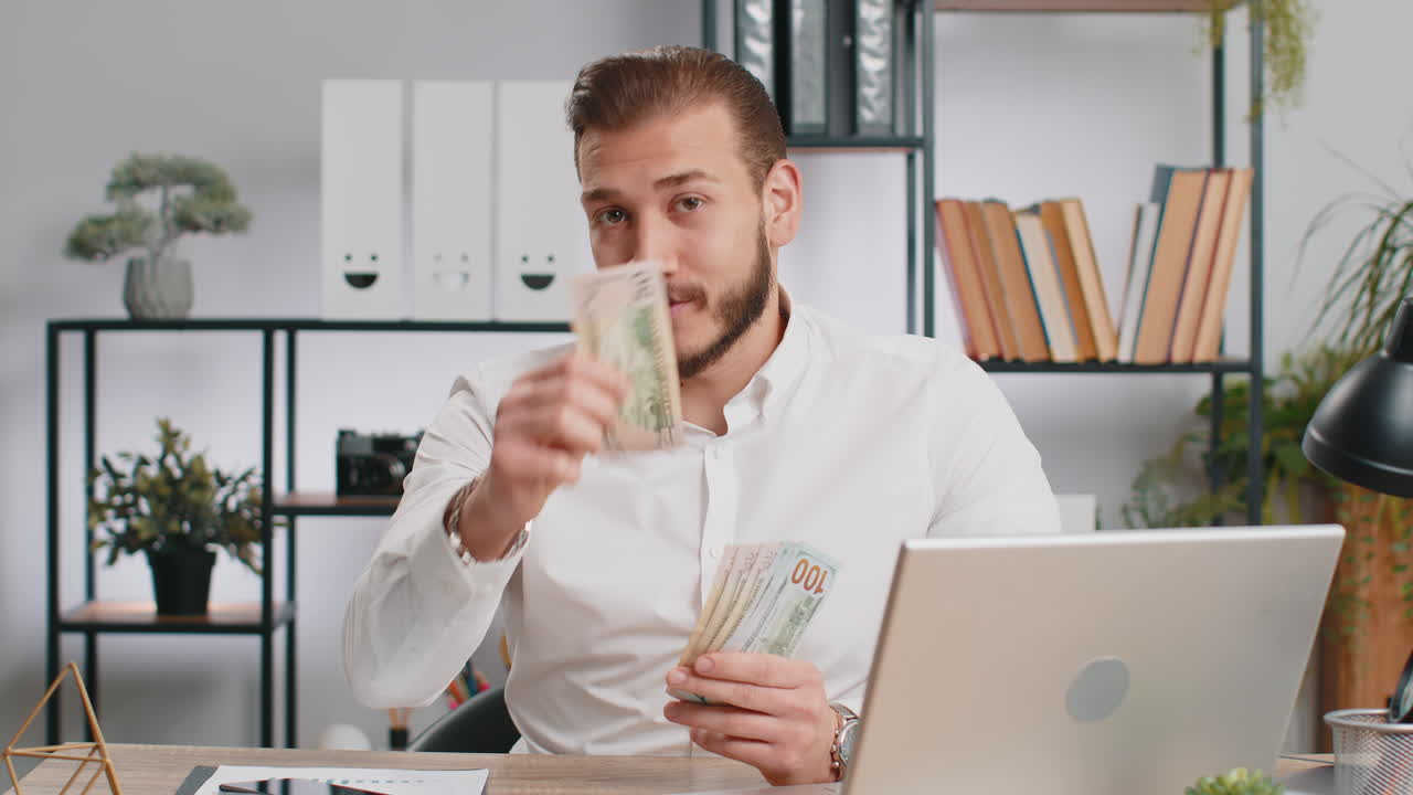 Young business man showing money dollar cash gives to you wages salary satisfied with good work