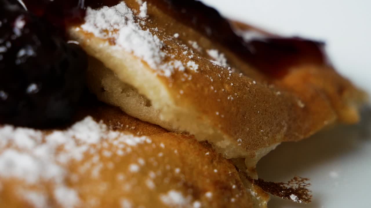 Tasty American Pancakes With Raspberries Jam on top in macro close up handheld shot