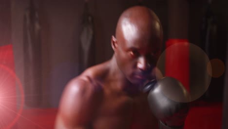 Animation-of-mixed-race-man-boxing-in-gym-with-spotlights-in-the-foreground