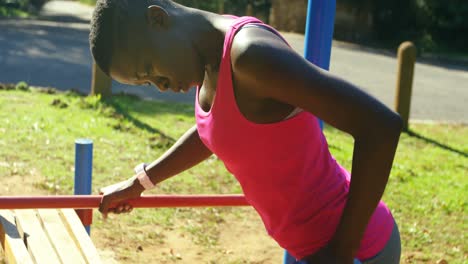 female athlete exercising with dumbbell in the park 4k