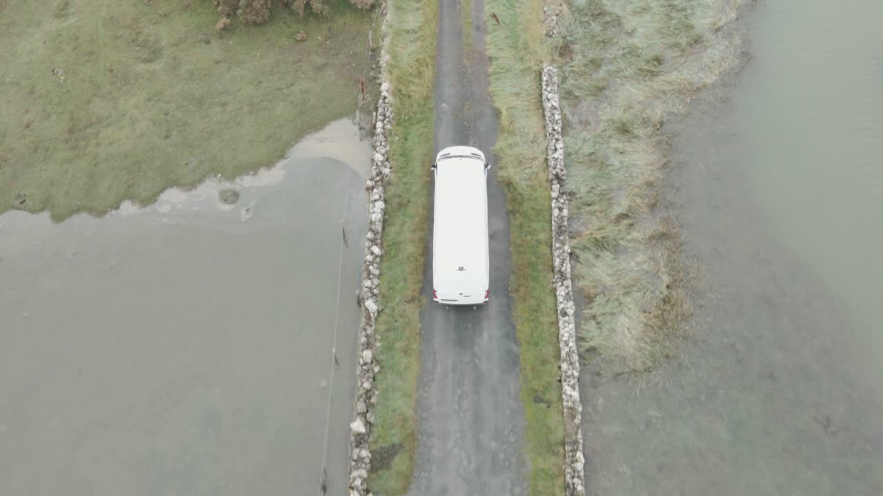 White Van Driving on a Lonely Country Road