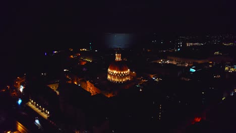 night time shot of basilica of our lady and full moon over valletta, malta