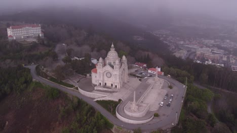 Establishing-Shot-of-Santuário-de-Santa-Luzia,-Viana-do-Castelo-Portugal-during-a-moody-day,-aerial