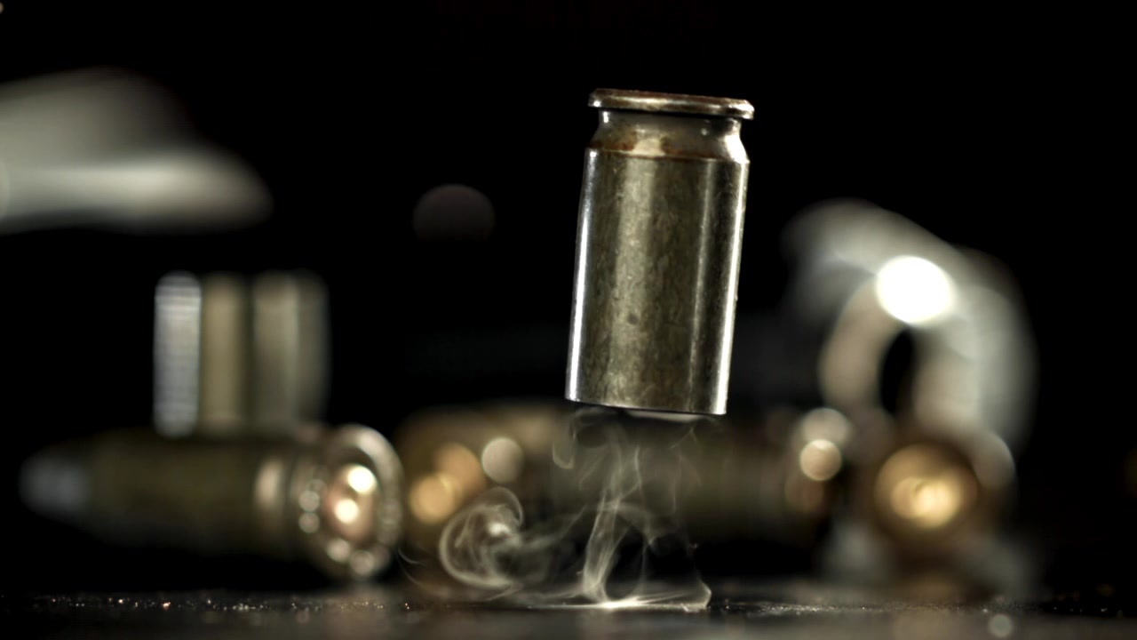 Hot Bullet Casing Falling and Smoking in Slow Motion