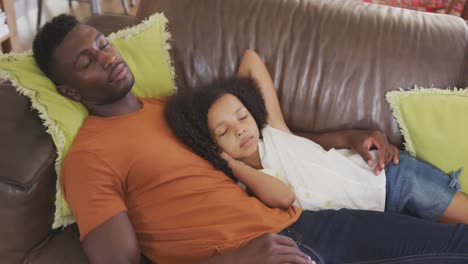 african american father and daughter sleeping in sofa