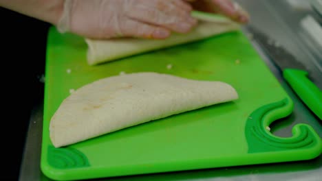 cu cook wraps the cooked wok with fried chicken and cheese