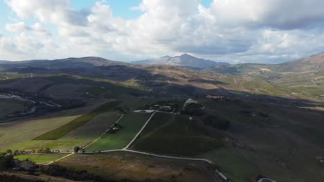 Horizontal-Pan-of-a-Sunny-Green-Valley-with-Puffy-Clouds-and-Blue-Summer-Skies