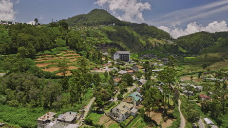 nuwara eliya sri lanka aerial v2 low level drone flyover along a5 pbc highway capturing hillside accommodations in bambarakelle with hilly mountain landscape view - shot with mavic 3 cine - april 2023