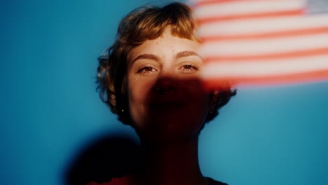 woman holding american flag with sparkler