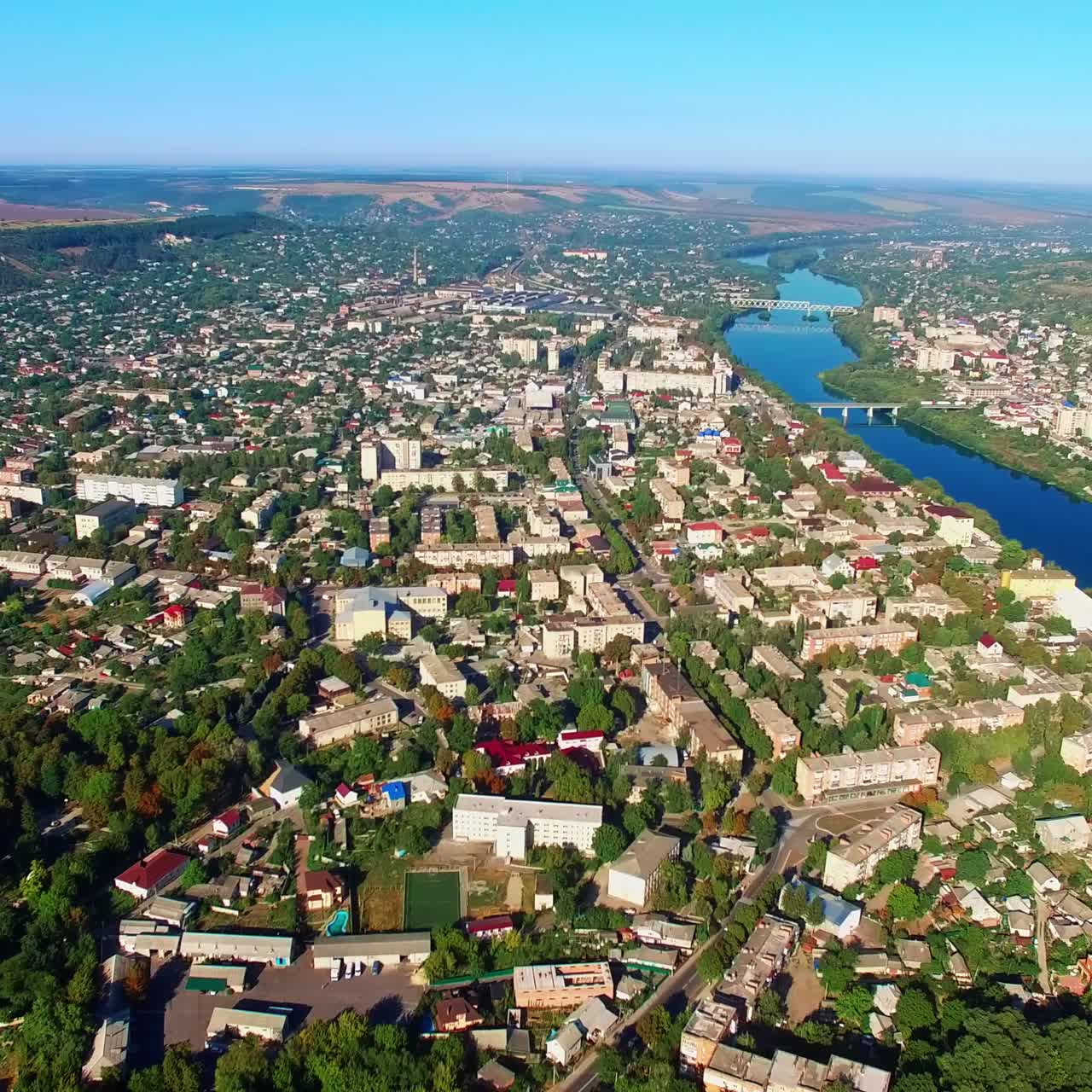Provincial urban territory on the beautiful river waterfront. Aerial view on sunny summer day