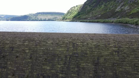 Caban-Coch-Dam,-Elan-Valley-Wales-rising-drone-to-reveal-reservoir