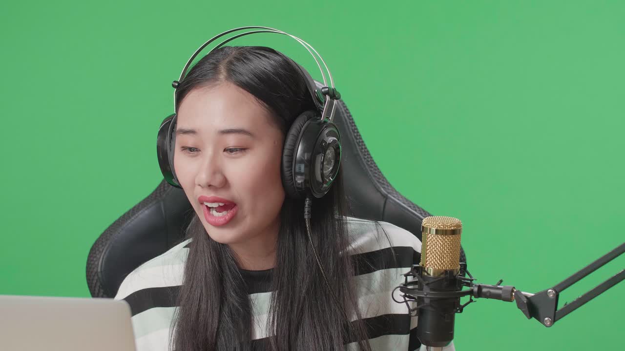 Woman streamer in a green screen studio