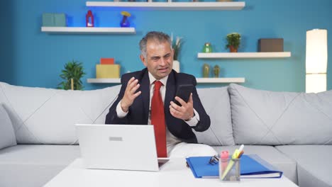 home office worker man getting bad news on the phone.