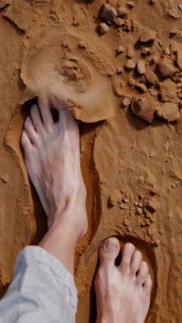 bare feet walking in sand