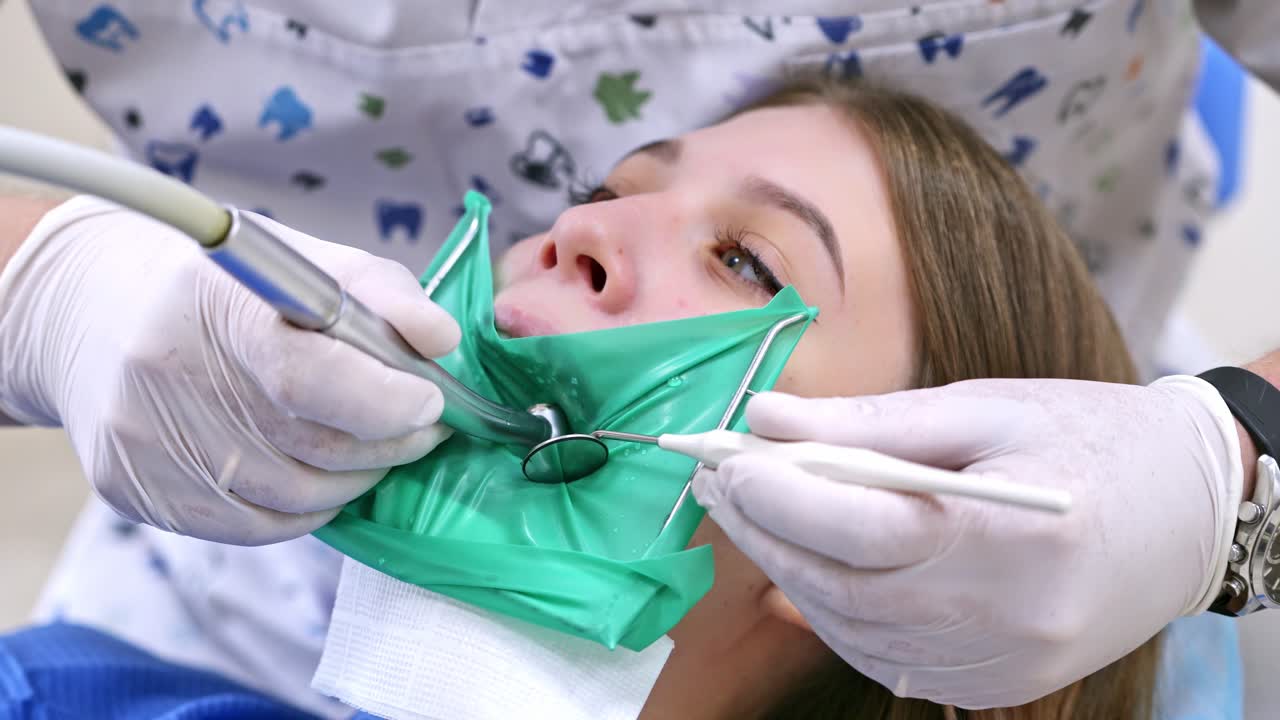 Patient in dental clinic on chair. Close up view of woman at dentist during treatment process at the dental clinic