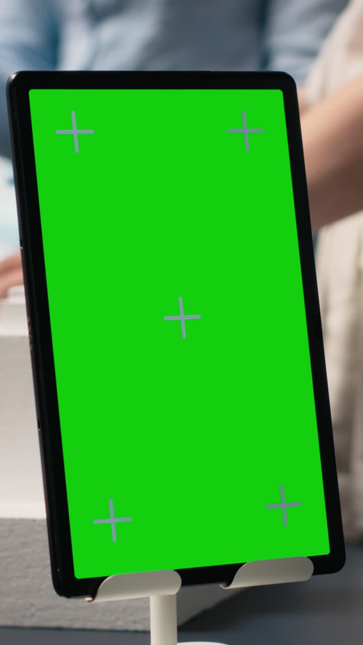 Vertical Video Engineers team share master plan ideas next to chroma key display