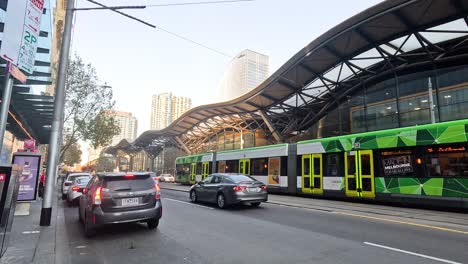 tram and cars crossing busy melbourne intersection