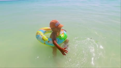 a child swims and plays with his buoy on the beach of jambiani zanzibar