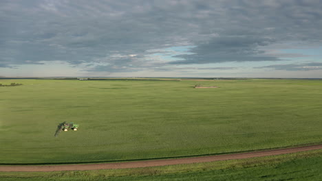 Cinematic-Tracking-shot-of-Tractor-Spraying-fungicide-on-cereal-crop