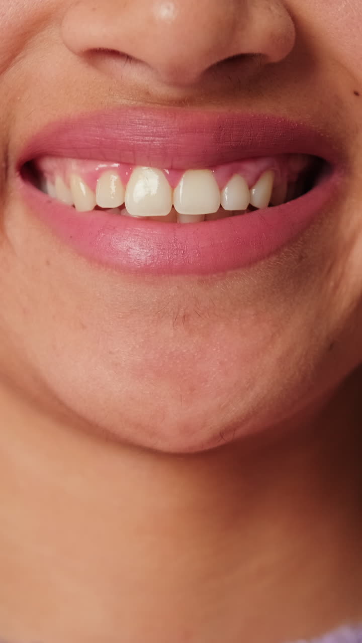 Close-up of a Woman's Mouth Smiling with Pink Lipstick