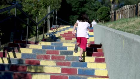Girl-child-climbing-colorful-pavements