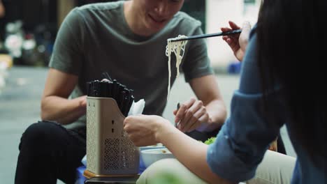 Handheld-view-of-couple-trying-Vietnamese-food