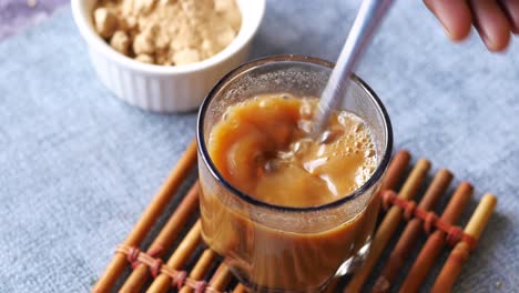 mixing a healthy tea drink with powder