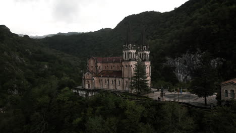 rising drone angle of santa maria basilica in the northern mountains of covadonga, spain