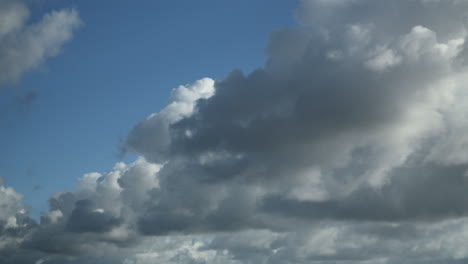 cumulonimbus clouds moving down towards the horizon