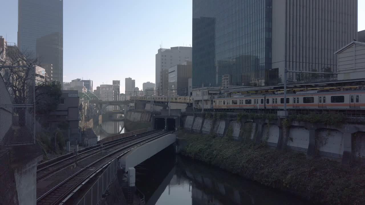 4k HD view to the Tokyo train railway and train station with many trains passing in winter daytime