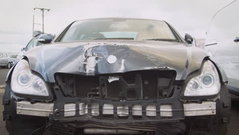 detail of car damaged in motor vehicle accident parked in garage repair shop