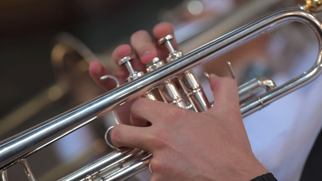 Musician playing a silver trumpet close up