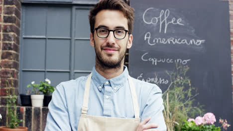 happy barista man portrait outside cafe