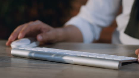 close up view of arabian businessman fingers typewriting on keyboard of computer on the desk in the office