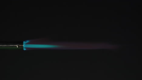 close-up of a butane torch with a blue flame