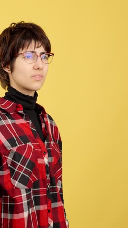 young person adjusting glasses and concentrating
