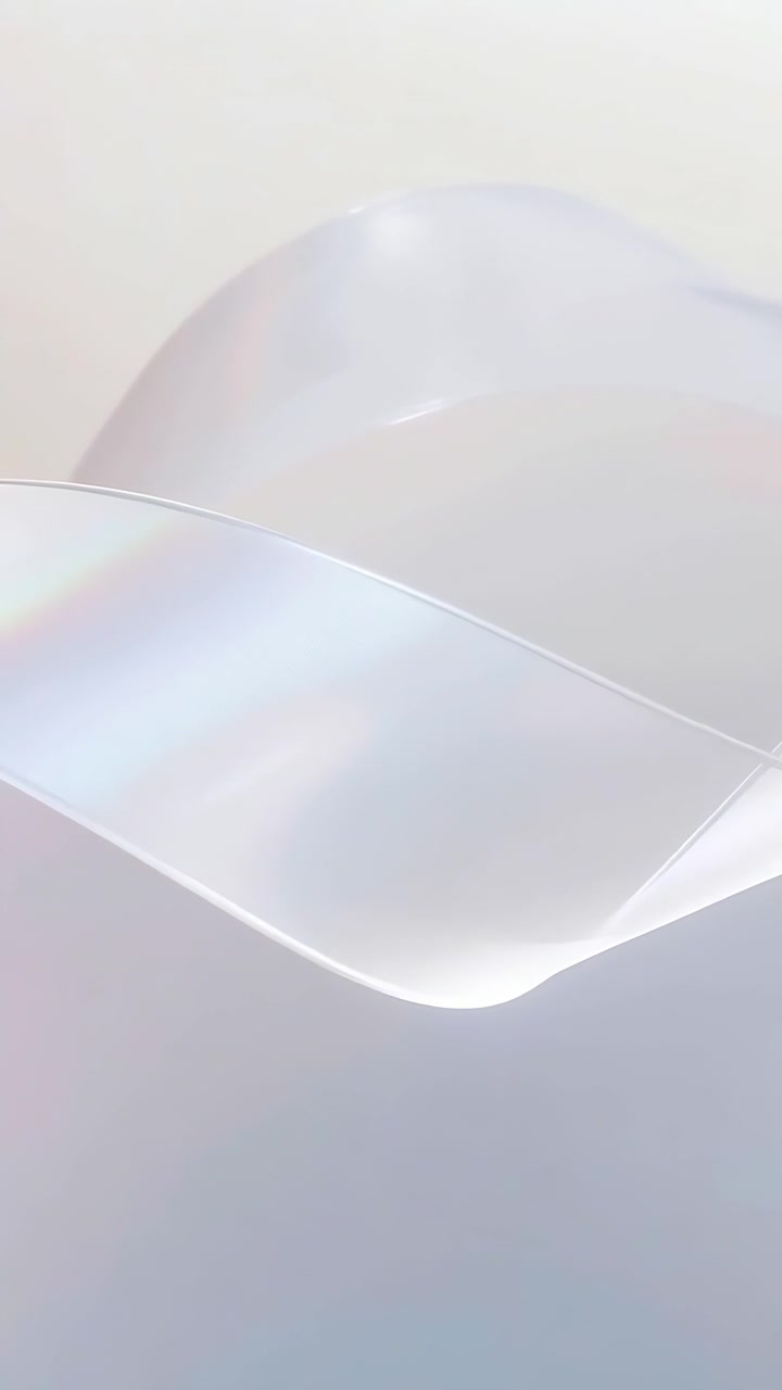 Vertical video: Frames starting, pearly ribbon undulating across pale backdrop, showing bright rim