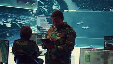 oficial militar mujer supervisando imágenes de vigilancia de radar