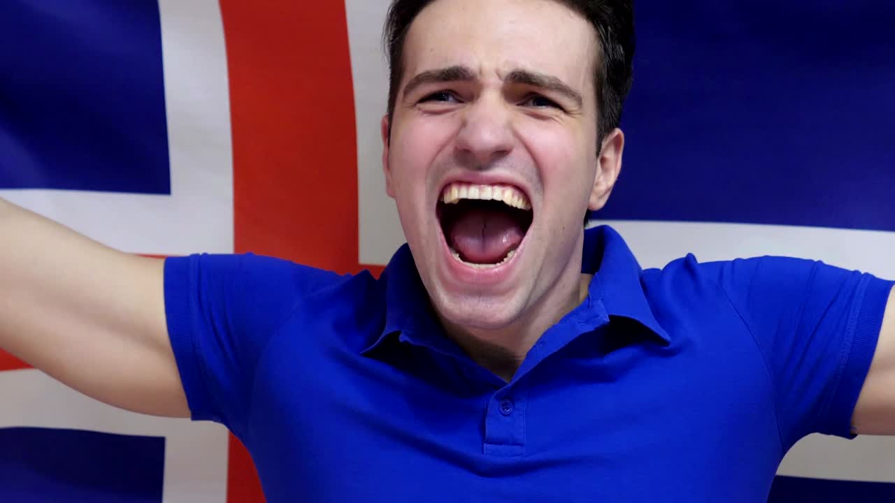 아이슬란드 젊은이가 슬로모션으로 아이슬란드의 발을 들고 축하합니다.