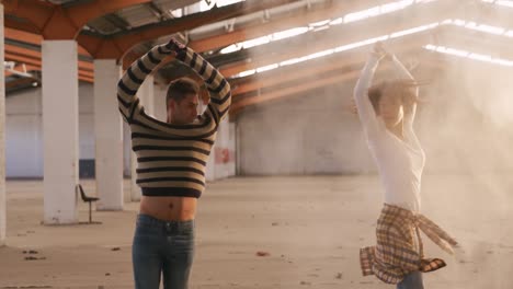 dancers in an empty warehouse